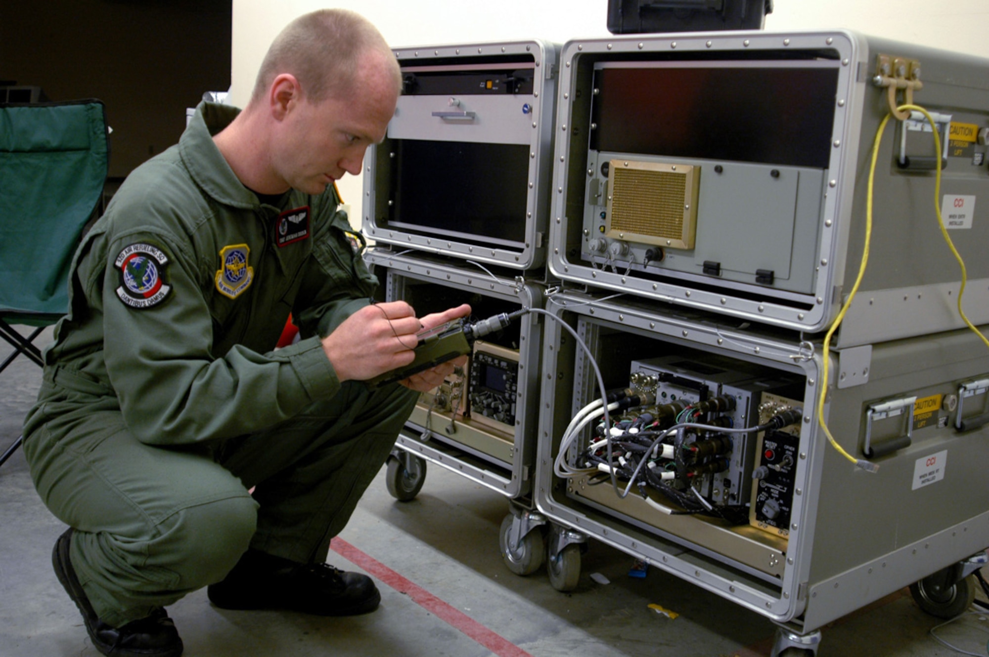 FAIRCHILD AIR FORCE BASE, Wash. (AFPN) -- Tech. Sgt. Jeremiah Docken loads data into a Roll-On Beyond Line-of-Sight Enhancement Spiral 2 kit as part of a training exercise Jan. 17. Two Airmen can load and attach the kit to a ROBE-enhanced KC-135 Stratotanker. Sergeant Docken is a boom operator with the 92nd Air Refueling Squadron. (U.S. Air Force photo by Staff Sgt. Nathan Gallahan) 