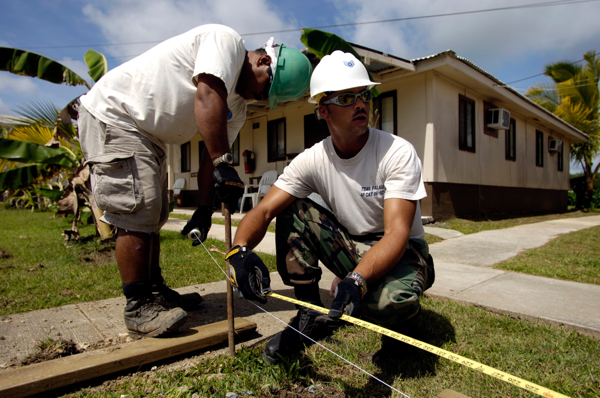 BABLEDAOB, Palau (AFPN) -- Heavy equipment operator Staff Sgt. Chris Nelson shows his Palauan apprentice how to properly run a line level to make sure everything is level for forming when pouring concrete. Sergeant Nelson is part of the Air Force civic action team here. The team's mission is twofold: help develop Palau's basic infrastructure development and provide a favorable U.S. military presence. The team does this through community construction, apprentice training, medical civic action program and community relations. (U.S. Air Force photo by Tech. Sgt. Shane A. Cuomo) 