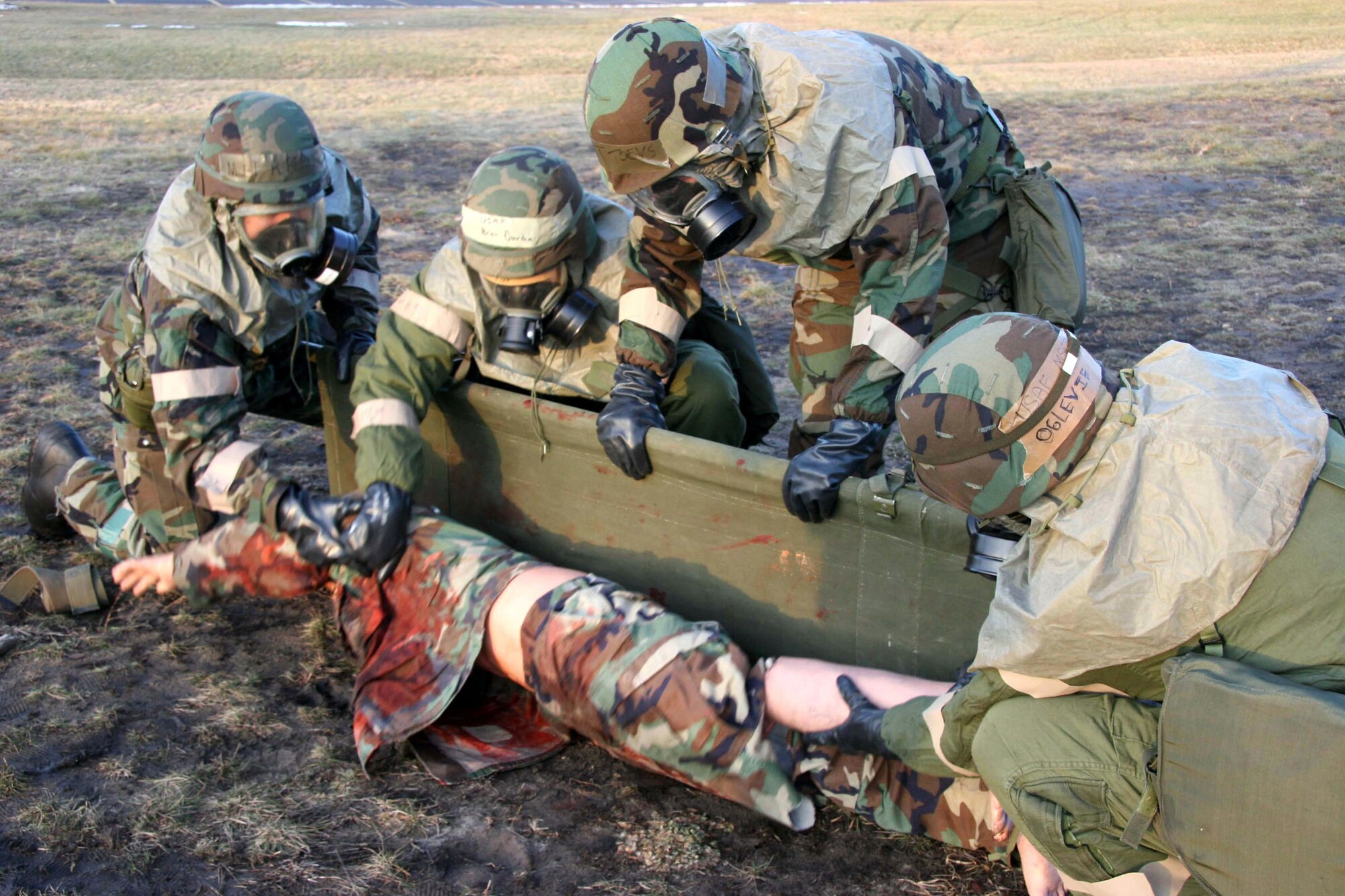 VOLK FIELD AIR NATIONAL GUARD BASE, Wis. (AFPN) -- After a simulated attack, members of the 939th Air Refueling Wing's litter team recover a "dead" Airman from an exercise field. A wing post attack response team reported the Airman's location to the survival and recovery center. The wing took part in the Air Force's first readiness safeguard command and control functional training exercise program here. (U.S. Air Force photo by Master Sgt. Ruby Zarzyczny) 