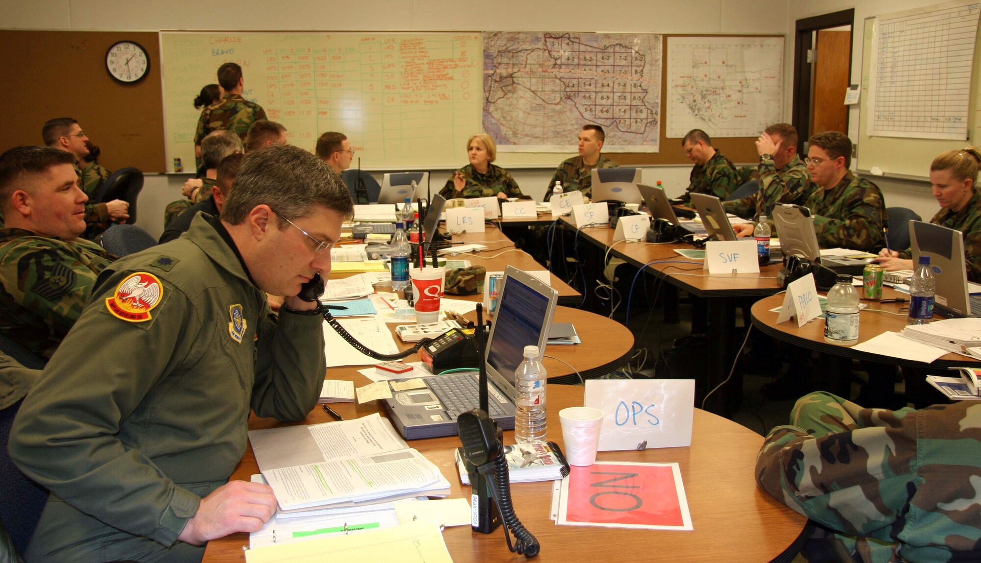 VOLK FIELD AIR NATIONAL GUARD BASE, Wis. (AFPN) -- While the steady hum of voice and ringing telephones fills the air, members of the 939th Air Refueling Wing's survival and recovery center practice gathering and flowing information as part of the Air Force's first readiness safeguard command and control functional training exercise program here. The center has representatives from wing support, maintenance, civil engineer and operations sections. (U.S. Air Force photo by Master Sgt. Ruby Zarzyczny) 