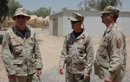 Capt. Ken Leonard (center), a reservist assigned to the 315th Airlift Wing, Charleston AFB, S.C., talks to his troops while deployed to Balad AB, Iraq. (Photo by 1Lt Wayne Capps, USAFR)