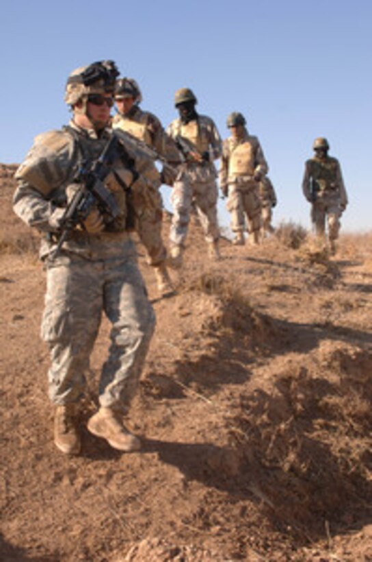 Soldiers from the U.S. Army's 101st Airborne Division and Iraqi Army search for a weapons cache on a farm outside of Hawijah, Iraq, on Jan. 4, 2006. The U.S. soldiers are attached to Alpha Company, 1st Battalion, 327th Infantry Regiment. 