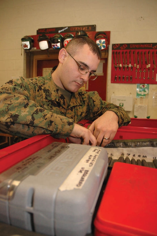 Cpl. Brandon J. Gallagher, Marine Attack Squadron 311 tool room noncommissioned officer-in-charge and native of Livermore, Calif., unrolls a case of float punches to count them at the end of his shift Jan. 19 in the VMA-311 hangar. If a tool is unaccounted for, all flights stop as proper administrative action is taken and a foreign objects and debris walk is conducted to find the missing tool.