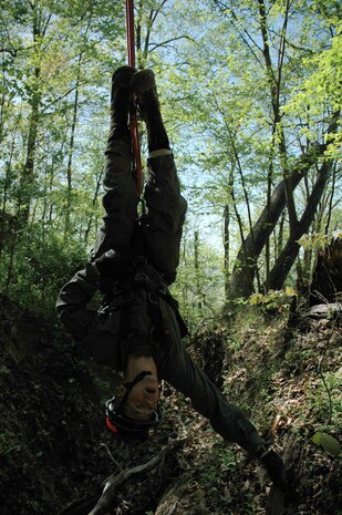INDIAN HEAD, Md. - Cpl. Ronald R. Seaver goes "inverted" during training at the Naval Support Facility Indian Head located here April 19.  While inverted a technician's feet are thrown above his waist and he is upside down, at times, several stories above the ground.  Going inverted is utilized if the mission requires the technician to be lowered down to the victim head first in order to assess the situation.