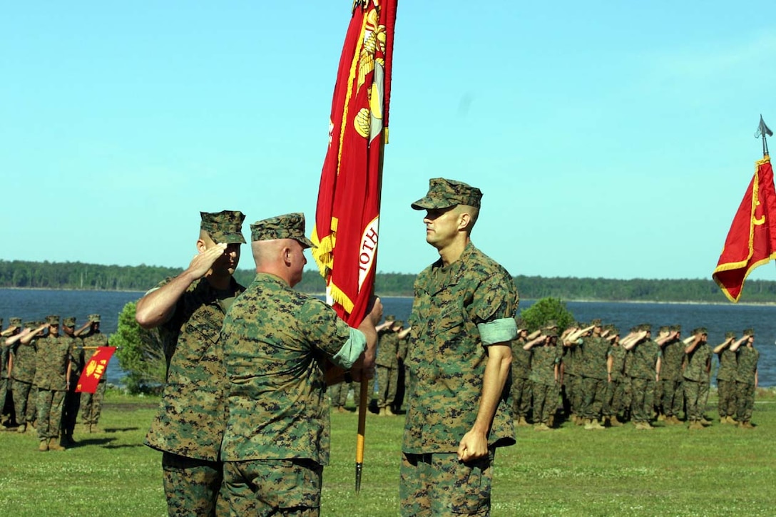 Lt. Col. Timothy M. Parker receives 2nd Battalion, 10th  Marine Regiment's colors from Lt. Col. Douglas P. Thomas during a change of command ceremony May 20. Parker plans on continuing in the footsteps left by Thomas, as they begin their preparation for their up and coming role in Iraq Freedom.
