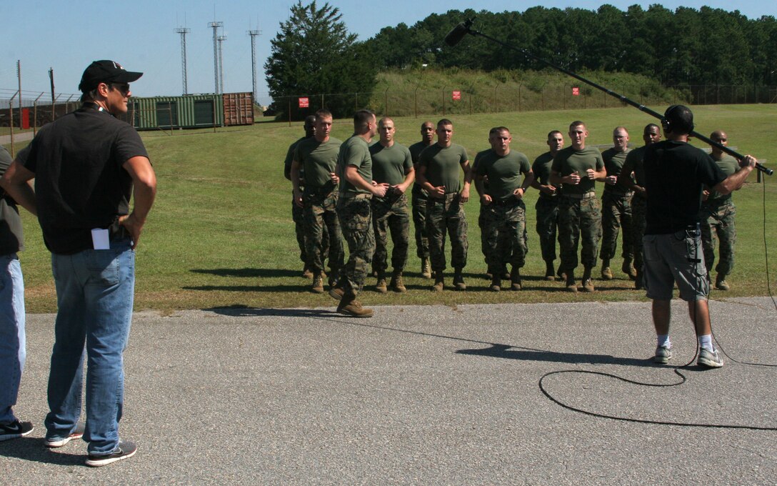 WILMINGTON, N.C. (September 20, 2006)- Marines with 2nd Marine Division record cadence for sound while Director Paul Johansson watches on. The Marines were extras on the television show "One Tree Hill." (Official U.S. Marine Corps photo by Cpl. Adam Testagrossa (RELEASED)