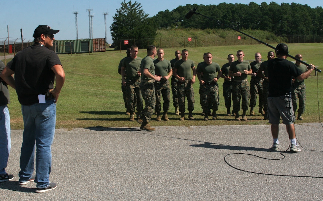 WILMINGTON, N.C. (September 20, 2006)- Marines with 2nd Marine Division record cadence for sound while Director Paul Johansson watches on. The Marines were extras on the television show "One Tree Hill." (Official U.S. Marine Corps photo by Cpl. Adam Testagrossa (RELEASED)