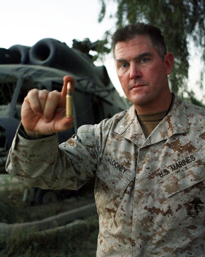 Lt. Col. Patrick Looney, battalion commander for 3rd Battalion, 5th Marine Regiment, holds the last round chambered in a Marine M-40A1 sniper rifle, which spent two years in enemy hands.  A 21-year-old sniper from Sniper Section Four killed the insurgent June 16.  The Darkhorse battalion plans to mount the round on a plaque to present to snipers of 2nd Battalion, 4th Marine Regiment Magnificent Bastards, who lost four Marines and the rifle in Ramadi in June 2004.