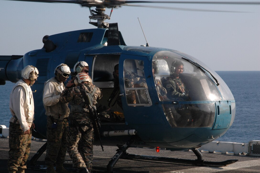 061020-N-5067K-009 USS Essex (LHD 2), At sea, Oct. 20, 2006 -- Philippine Naval Special Operations Group (NAVSOG) SEAL sniper team exits a Philippine Navy BO-105C helicopter and they rotate teams for High Angle Sniping training with U.S. Marine Corps Special Operations Training Group (SOTG) instructors as part of Amphibious Landing Exercise (PHIBLEX '07) and Talon Vision (TV 07).  PHIBLEX and Talon Vision are bilateral exercises between the United States and the Republic of the Philippines designed to increase military interoperability and cultural ties. Essex is part of the Essex Amphibious Ready Group also comprised of the dock landing ship USS Harpers Ferry (LSD 49) and the transport dock ship USS Juneau (LPD 10) all based in Sasebo, Japan. (U.S. Navy Photo by Mass Communications Specialist 1st Class Michael D. Kennedy)