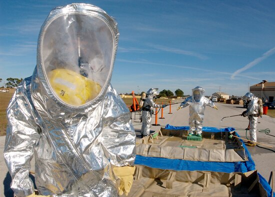 MACDILL AIR FORCE BASE, Fla. (AFPN) -- Senior Airman Roy Heron III waits for James Gambino to process through the first station of the decontamination line during the Emergency Management Exercise here Jan. 18.  The EME prepares emergency teams for real world situations. The two men are firefighters with the 6th Civil Engineering Squadron.  (U.S. Air Force photo by Senior Airman Carlye D. La Pointe)