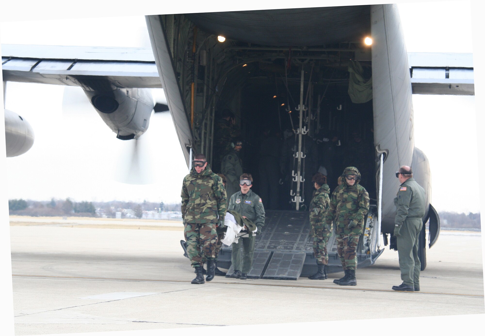 WRIGHT-PATTERSON AFB, Ohio -- (left to right) Senior Airman John Cranor and Maj. Sheri Gladish carry a "patient" from a C-130 during a aeromedical exercise as SrA Mark Magalski and Col. Allen Gilbar look on.  (U.S. Air Force Photo by MSgt. Doug Moore)