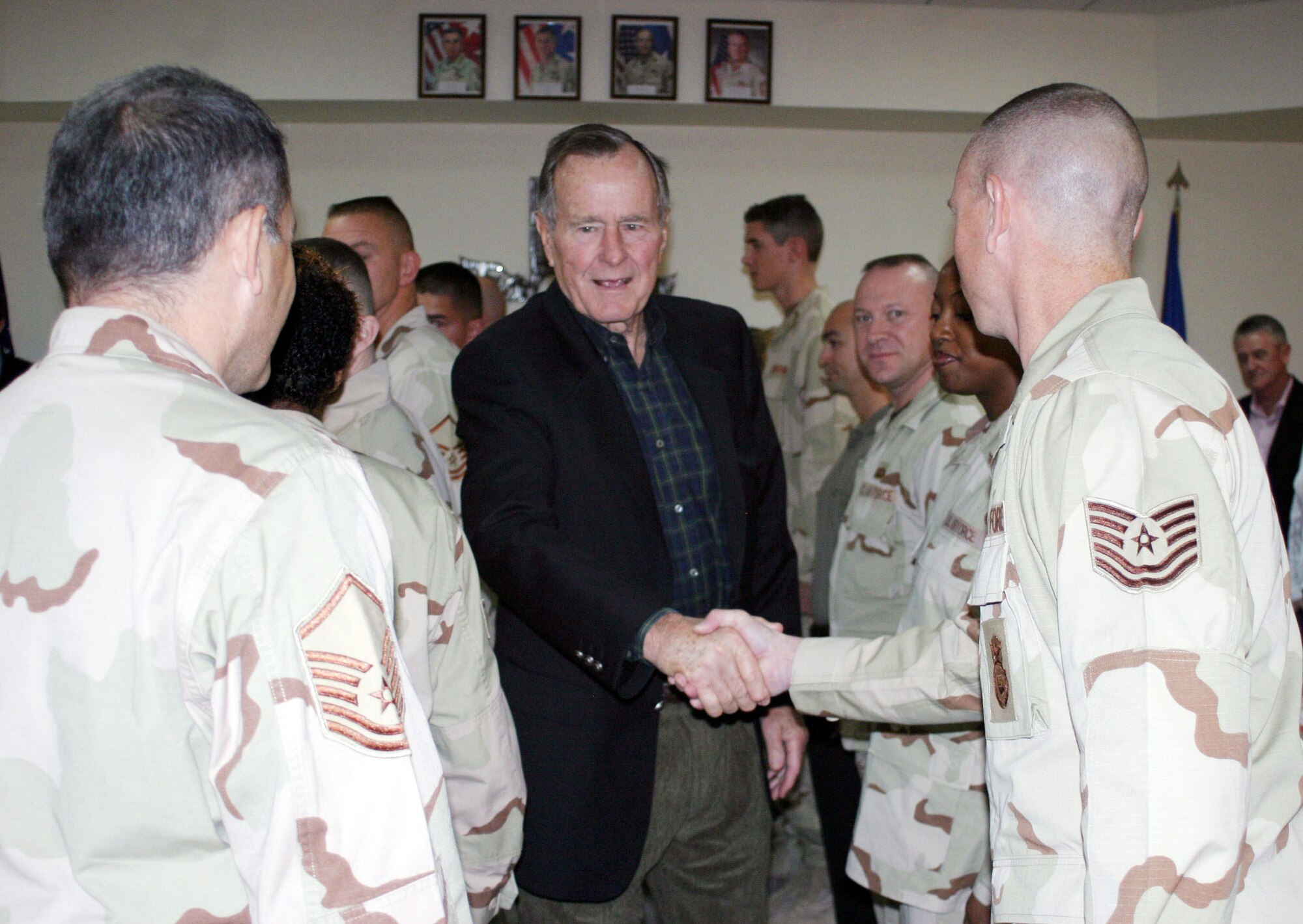 SOUTHWEST ASIA (AFPN) -- Former President George H. W. Bush shakes hands with Airmen and Sailors during his recent visit here. (U.S. Navy photo by Petty Officer 2nd Class Jennifer L. Bailey)