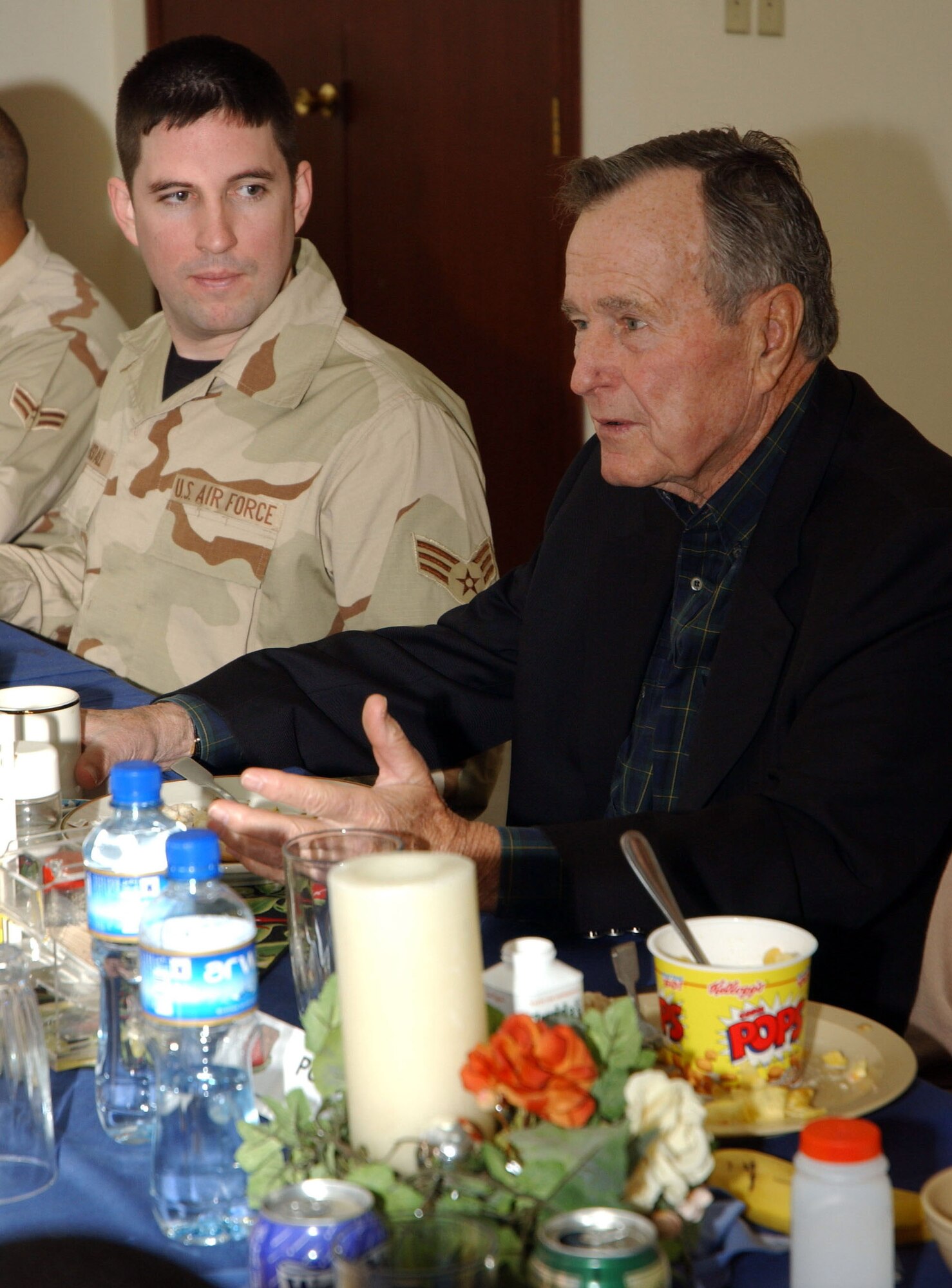 SOUTHWEST ASIA (AFPN) -- Former President, George H. W. Bush, meets with troops for breakfast during a visit this week to a deployed location in Southwest Asia. To the former president's right is Senior Airman Jonathan Cansdale, deployed from the 354th Fighter Wing at Eielson Air Force Base, Alaska. (U.S. Air Force photo by Airman 1st Class Anthony Nelson)