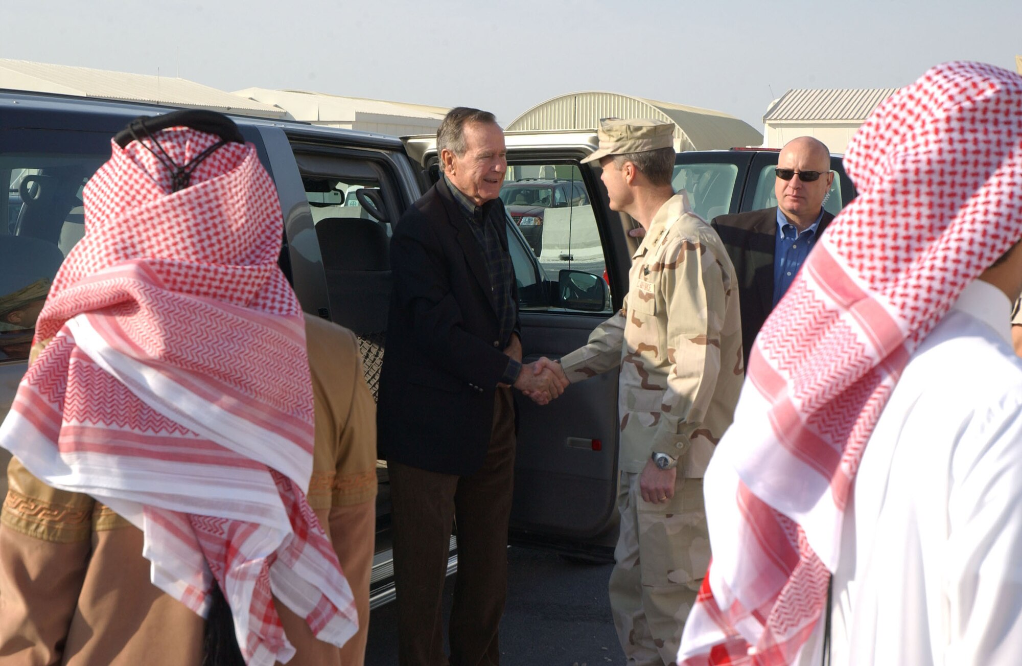 SOUTHWEST ASIA (AFPN) -- Former President, George H. W. Bush, is greeted by Maj. Gen. Allen G. Peck during the former president's visit this week to Southwest Asia. General Peck is Deputy Combined Forces Air Component commander, U.S. Central Command.  (U.S. Air Force photo by Airman 1st Class Anthony Nelson)