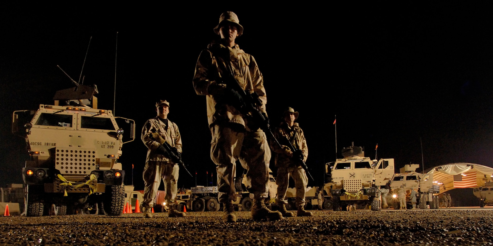 BALAD AIR BASE, Iraq -- (From left) Tech. Sgt. Andrew Morin and Staff Sgts. Jeremy Garcia and Frank Stibler keep an eye on how the 181st Transportation Battalion's convoy security team prepare their convoy escort platforms and rehearse a "snatch and grab" procedure. (U.S. Air Force photo by Master Sgt. Lance Cheung)
