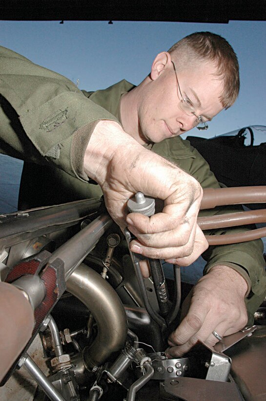 Cpl. Erik I. Thomas, Marine Attack Squadron 513 powerline mechanic and native of Dallas, secures bolts on an AV-8B Harrier II engine during an engine change Friday at VMA-513?s hangar. VMA-513 is preparing to deploy in February to Iraq, which has the squadron preparing both mechanically and mentally. Marines have been updating record books and insurance information, as well as preparing their families for the deployment.