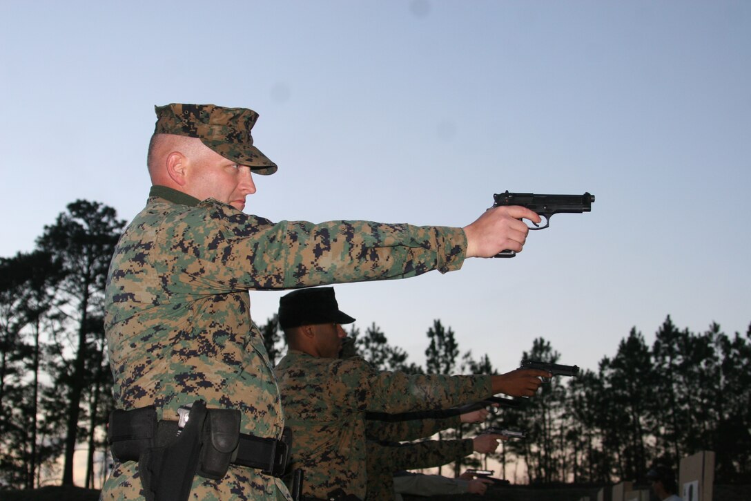 Gunnery Sgt. David Perry, Station range chief, conducts annual low-light weapons training with the Marines of the Headquarters and Headquarters Squadron Provost Marshal?s Office, Feb. 28.