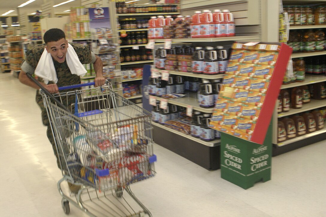 MARINE CORPS BASE CAMP LEJEUNE, N.C. - A Marine dashes down the commissary aisles here May 22 as he races against others to retrieve items throughout the store.  Commissary staff, the Semper Fit girls and Single Marine Program personnel hosted this Commissary Awareness Month event that included tours, physically and mentally challenging games, and "Supermarket Sweep"-style races, all meant to enhance single service members' knowledge of the savings and goods available at their base's commissary.