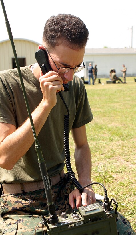 Lance Cpl. Adrian M. Negron, 26th Marine Expeditionary Unit radio operator, works to establish communications during a field exercise aboard Marine Corps Auxiliary Landing Field, Bogue, N.C.