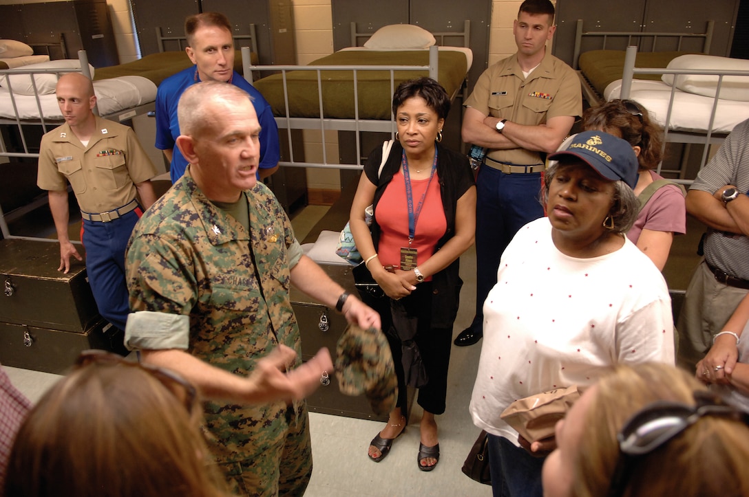 Colonel Robert H. Chase, commanding officer, Officer Candidate School, takes educators from 4th Marine Corps Recruiting District on a tour of the facilities around OCS.  The educators received an inside look at the barracks and the living arrangements of candidates going through training.
