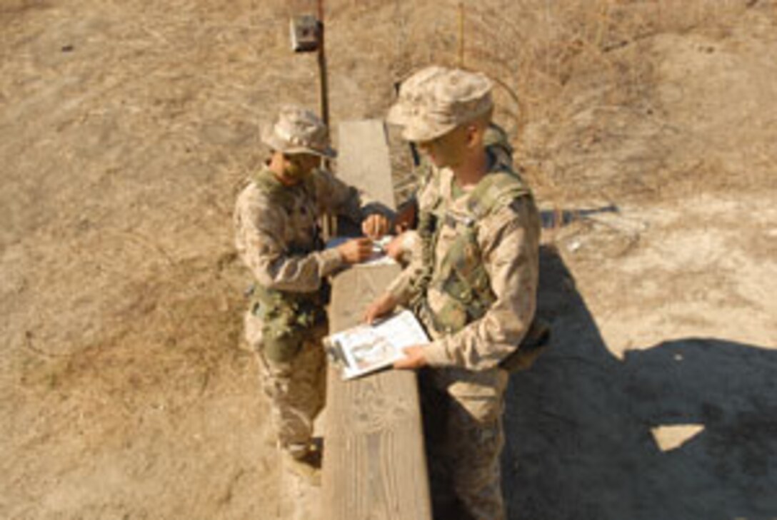 A Company M fire team takes a minute to determine the direction of its next navigation objective.