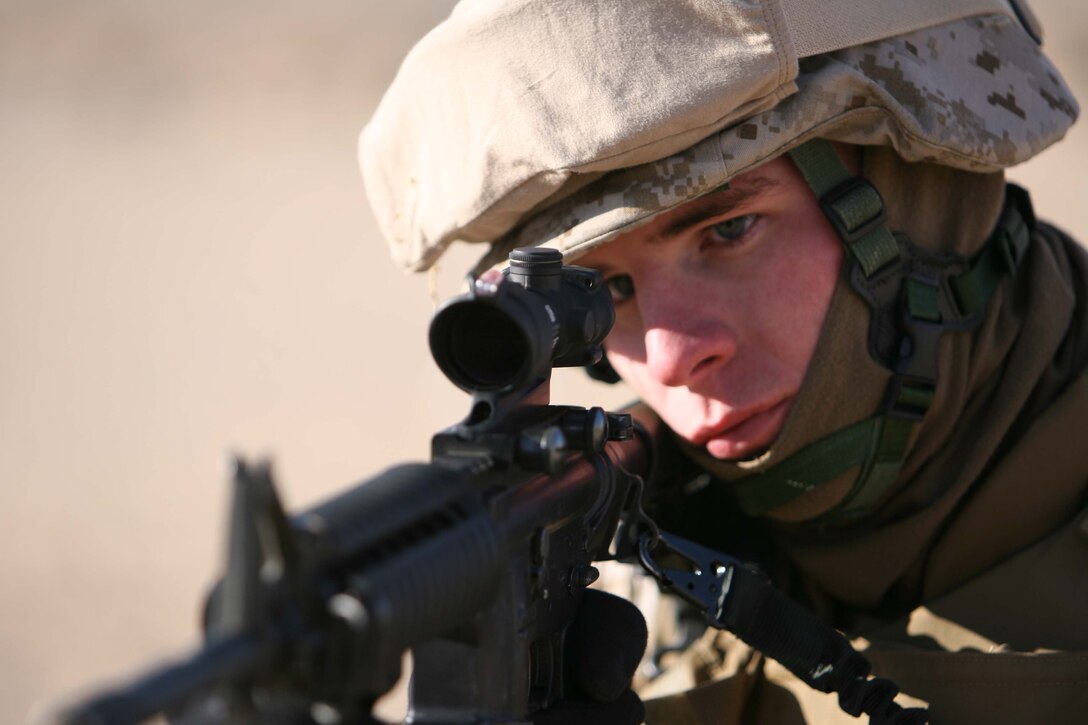 Sgt. Daniel R. Liscinsky, a 22-year-old fron Milford, C.T. and Intelligence Speciallist for 3rd Battalion, 8th Marine Regiment's Military Transistion Team simulates fire and manuever procedures during the Enhanced Marksmanship Progam at a training exercise at Marine Corps Air Ground Comabat Cenert Twentynine Palms. The goal of MTT is to train and mentor the Iraqi Security Forces.