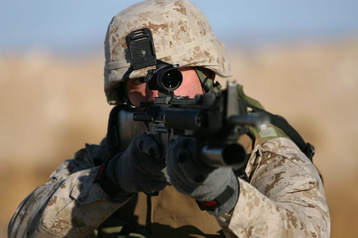 Lance Cpl. Brent R. Boek, team leader for 1st Platoon, Company I, 3rd Battalion, 8th Marine Regiment scopes out his target during a demonstration of marksman ship techniqies. 3rd Bn., 8th Marines are conducting their Mojave Viper exercise at Twentynine Palms Calif. the unit will deploy in support of Operation Iraqi Freedom in March.