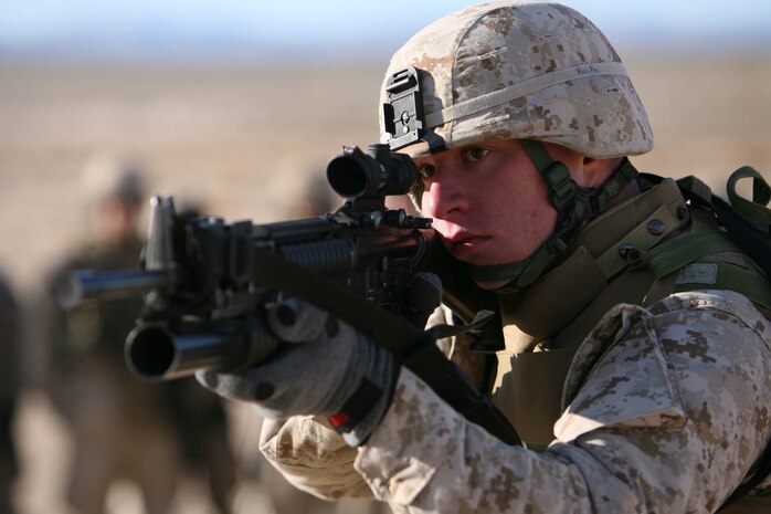Lance Cpl. Brent R. Boek, team leader for 1st Platoon, Company I, 3rd Battalion, 8th Marine Regiment scopes out his target during a demonstration of marksman ship techniqies. 3rd Bn., 8th Marines are conducting the Mojave Viper training at Twentynine Palms Calif. the unit will deploy in support of Operation Iraqi Freedom in March.