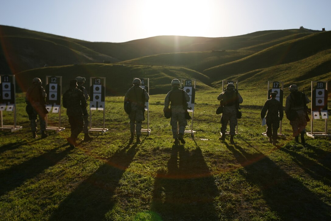 MARINE CORPS BASE CAMP PENDLETON, Calif. -Marines advance to their targets in order to review them after a stage of fire during enhanced marksmanship training Jan. 21. The landing support specialists, or red patches, of 4th Marine Logistics Group are undergoing pre-deployment training before they deploy in support of Operation Iraqi Freedom.