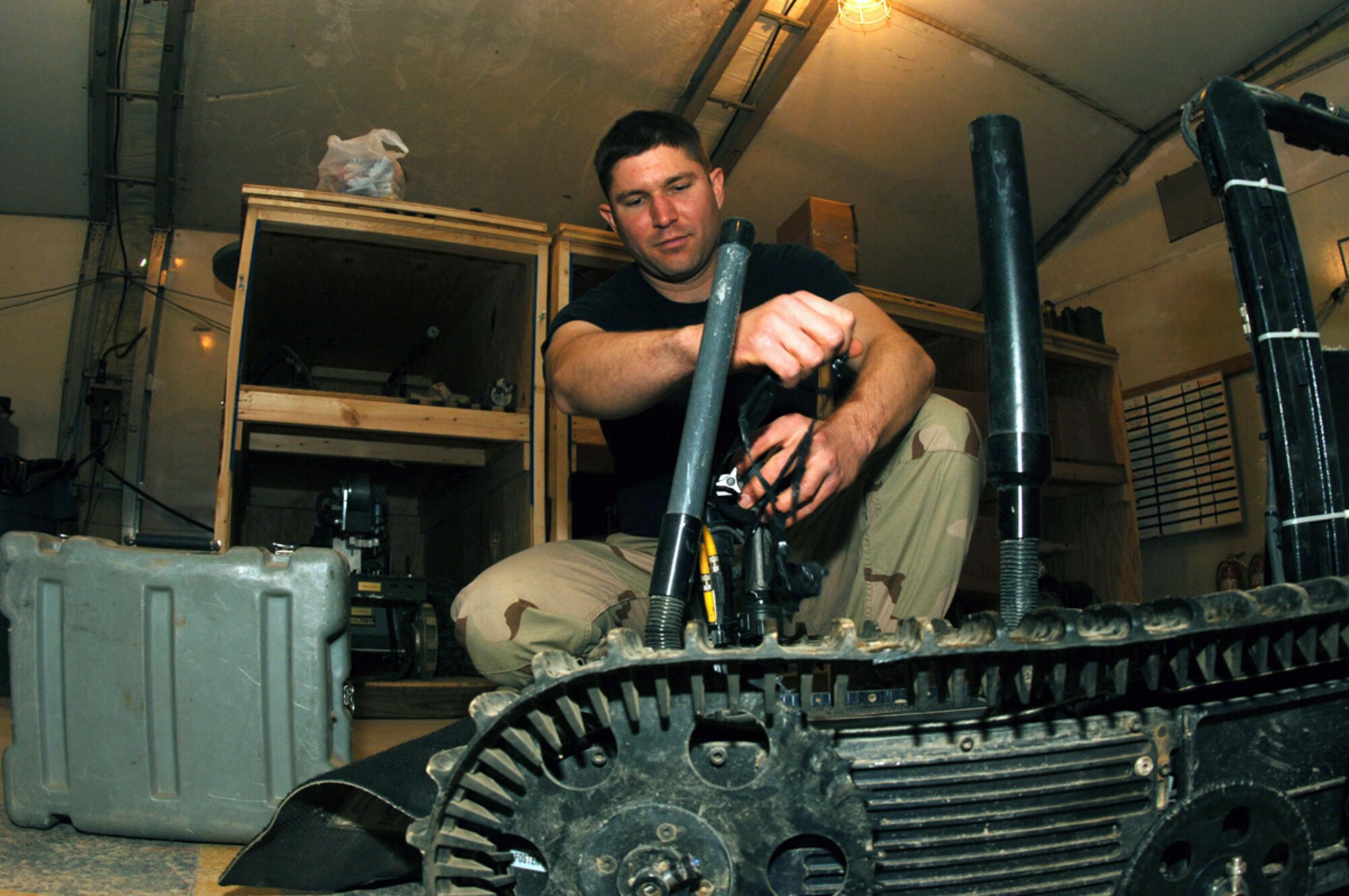 BALAD AIR BASE, Iraq (AFPN) -- Staff Sgt. Glenn Wright repairs an EOD robot used to scope the area before going out to a site. Sergeant Wright is with the 332nd Expeditionary Civil Engineer Squadron. (U.S. Air Force photo by Airman 1st Class Jessica Fuentez)