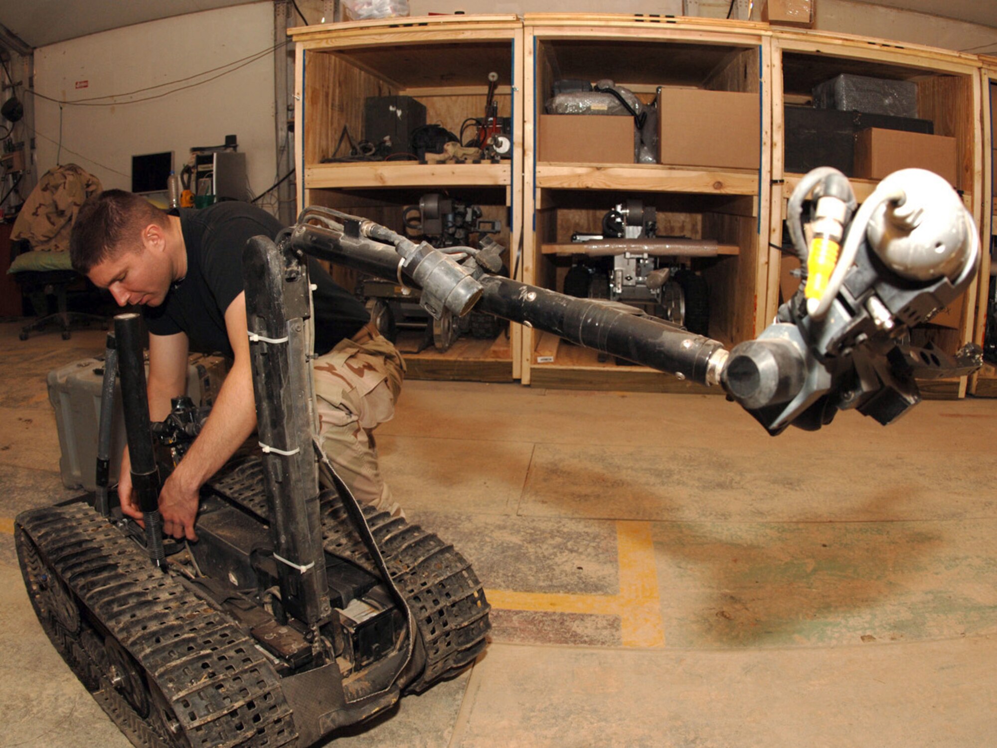 BALAD AIR BASE, Iraq (AFPN) -- Staff Sgt. Glenn Wright repairs an explosive ordinance disposal robot used to scope the area before going out to a site. Sergeant Wright is with the 332nd Expeditionary Civil Engineer Squadron. (U.S. Air Force photo by Airman 1st Class Jessica Fuentez)