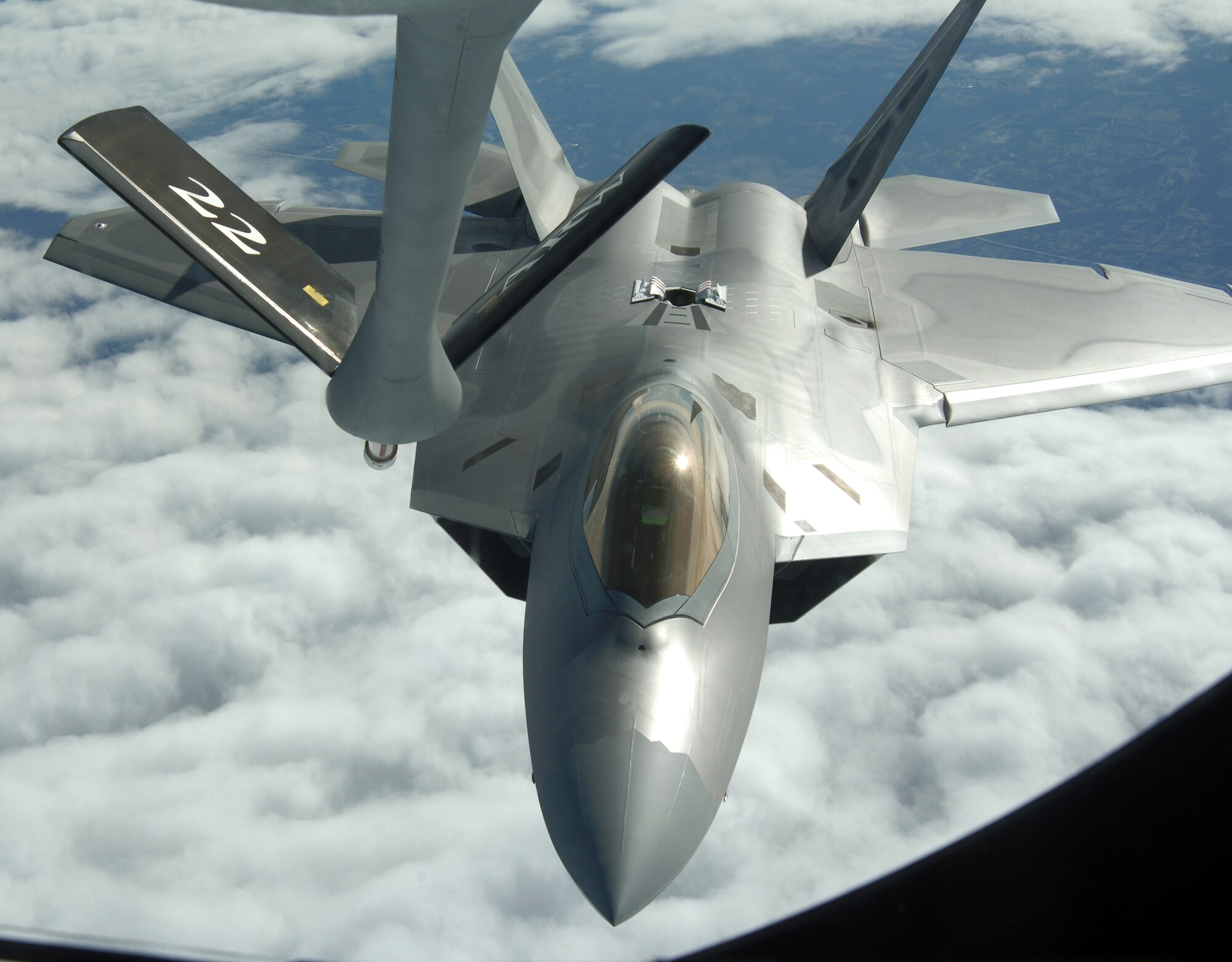 OVER THE UNITED STATES (AFPN) -- An F-22A Raptor from Langley Air Force Base, Va., refuels with a KC-135 Stratotanker from McConnell AFB, Kan., during the Raptor's first operational mission Jan. 21. The mission was flown in support of Operation Noble Eagle. The KC-135 was flown by the 18th Air Refueling Squadron. The F-22A was with the 27th Fighter Squadron. (U.S. Air Force photo by Master Sgt. Maurice Hessel)