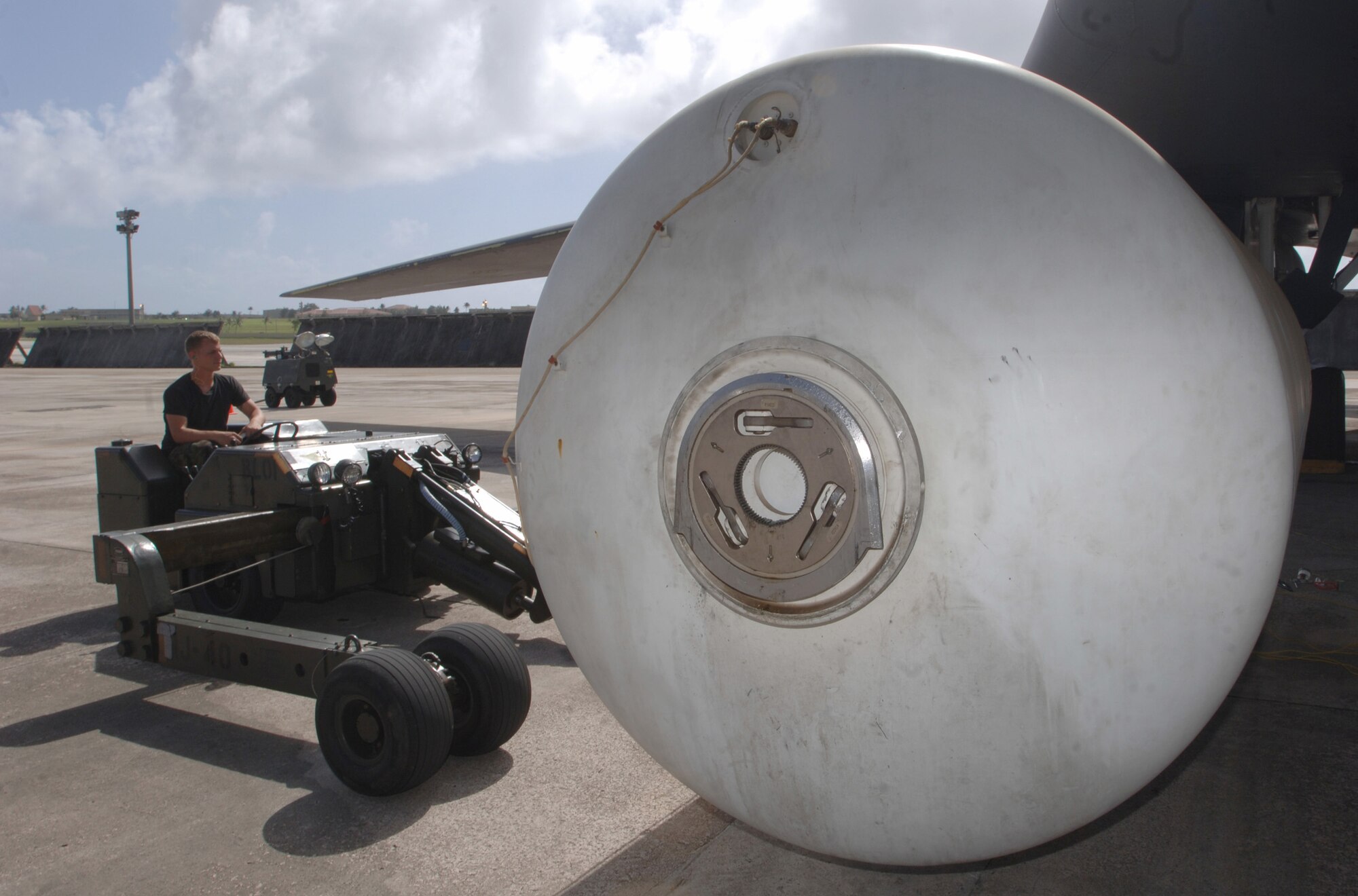 ANDERSEN AIR FORCE BASE, Guam (AFPN) -- Senior Airman James Underhill operates a "jammer" while lowering the weapons bay fuel tank of a B-1B Lancer during an inspection here. Airman Underhill, a crew chief from the 28th Aircraft Maintenance Squadron at Ellsworth Air Force Base, S.D., is here for an air and space expeditionary deployment. (U.S. Air Force photo by Master Sgt. Val Gempis)