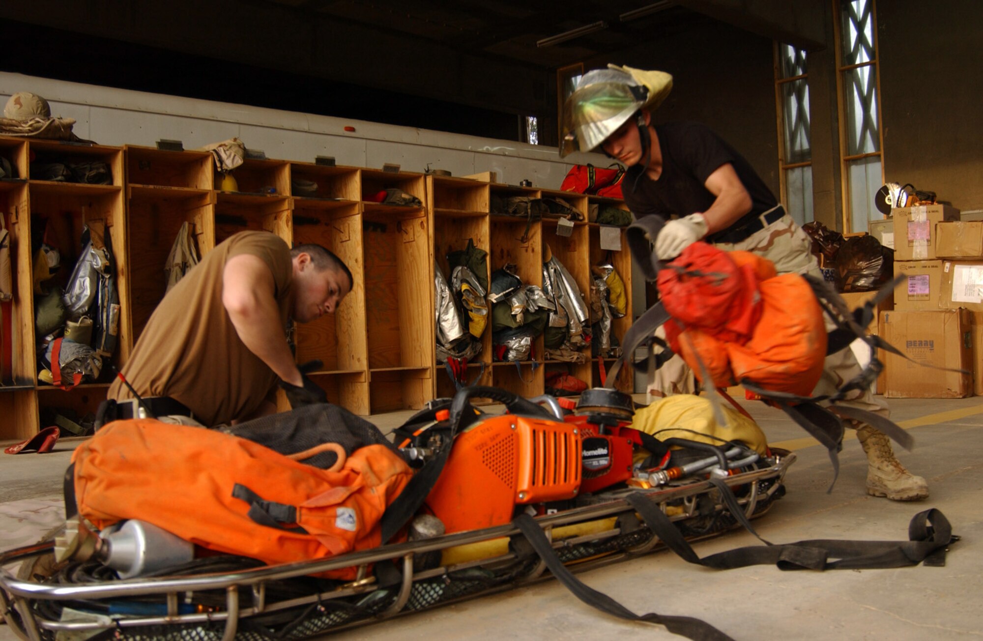 BALAD AIR BASE, Iraq (AFPN) -- Airman 1st Class Nathan Shaw and Senior Airman John  Armstrong inventory 350 pounds of extrication tools. Both Airmen are assigned to the 332nd Expeditionary Civil Engineering Squadron Fire Prevention Flight. (U.S. Air Force photo by Tech. Sgt. Pamela Anderson)                             