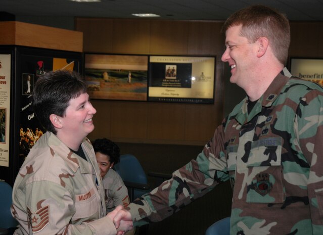 Lt. Col. John Tree, commander of the 38th Aerial Port Squadron at Charleston AFB, S.C., wishes Tech. Sgt. Gail Muiter well as she departs for a long deployment. (Photo by 1st Lt. Wayne Capps, USAFR)