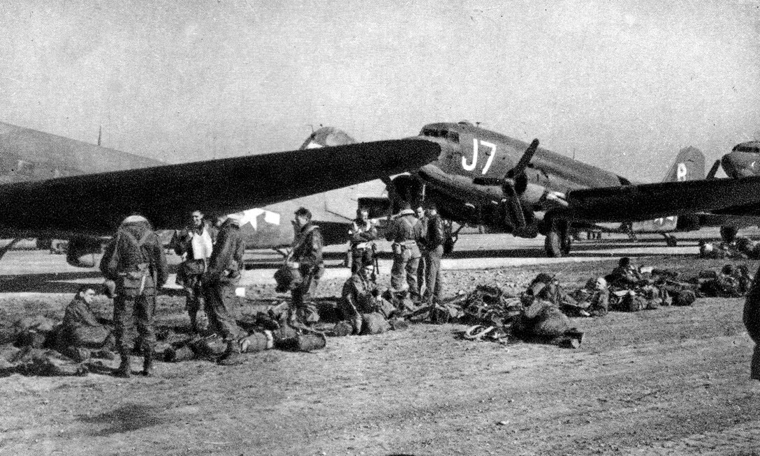 Members of the 303rd Troop Carrier Squadron, 442nd Troop Carrier Group, prepare to launch C-47 aircraft to carry American soldiers across the Rhine River into Germany during World War II.  Part of the job of the wing historian is to preserve documents and photos to remember events in a unit's history such as this momentous occassion.