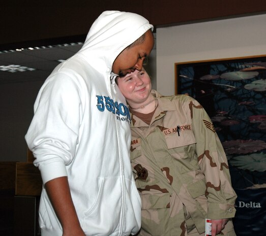 Staff Sgt, Jennifer Alcantara, a reservist assigned to the 81st Aerial Port Squadron at Charleston AFB, S.C., and her husband Christian embrace as Staff Sgt. Alcantara gets ready to depart on a long deployment. (Photo by 1st Lt. Wayne Capps, USAFR) 