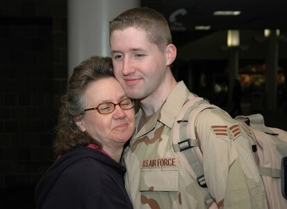 Saying goodbye; Senior Airman Joseph Speer, a reservist assigned to the 81st Aerial Port Squadron at Charleston AFB, S.C., hugs his mother Shirley while waiting to leave for a long deployment in Kuwait. (photo by 1st Lt. Wayne Capps, USAFR)
