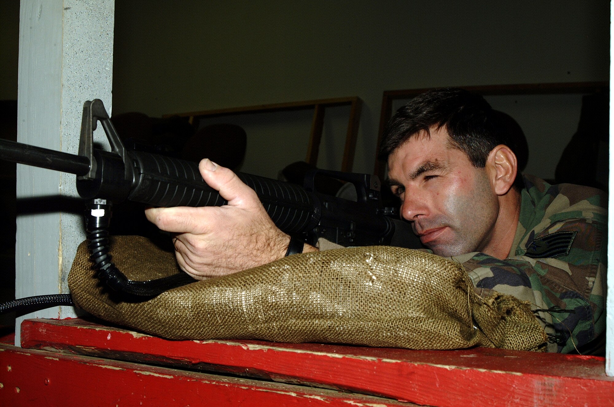 Tech. Sgt. Rob Fischer, 442nd Security Forces Squadron, demonstrates how to take aim with the M-16A2 at the computer-simulated firing range.  The 442nd SFS is part of the 442nd Fighter Wing, an Air Force Reserve wing at Whiteman Air Force Base, Mo.  (Photo by Staff Sgt. Angela Blazier)
