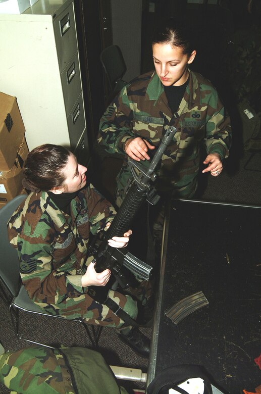Staff Sgt. Bridget Lund (right), 442nd Security Forces Squadron, instructs Tech. Sgt. Amy Borden, 442nd Mission Support Flight, about the proper use of the M-16A2 at a recent combat arms training class during the 442nd Fighter Wing's January unit training assembly.  The 442nd FW is an Air Force Reserve unit, based at Whiteman Air Force Base, Mo.