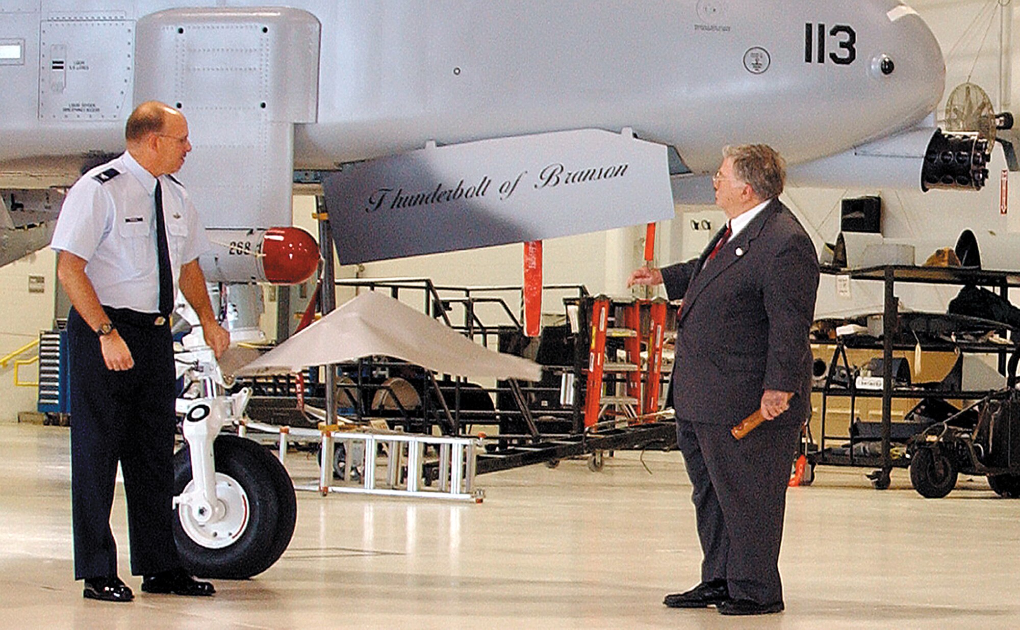 WHITEMAN AIR FORCE BASE, Mo. -- Col. Mark Ronco, Air Force reservist and vice commander of the 442nd Fighter Wing, along with Branson Mayor Louis Schaefer, unveil the "Thunderbolt of Branson" at a ceremony Jan. 8 in the 442nd FW's 5-Bay maintenance hangar here.  Colonel Ronco said the dedication was in recognition of the City of Branson's support of the Air Force, veterans and the 442nd Fighter Wing.  The wing has 13 of its 15 A-10 Thunderbolt II aircraft dedicated to cities in Missouri.  (Photo by Master Sgt. William Huntington)