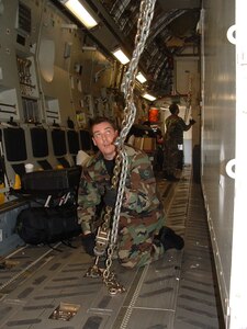 Charleston AFB, SC - TSgt Vaughn Mangum, a reservist with the 315th Airlift Wing's 81st APS,  checks tiedowns on heavy uploads during training mission. (photo by Chief Master Sgt. Charlie Hall, USAFR)