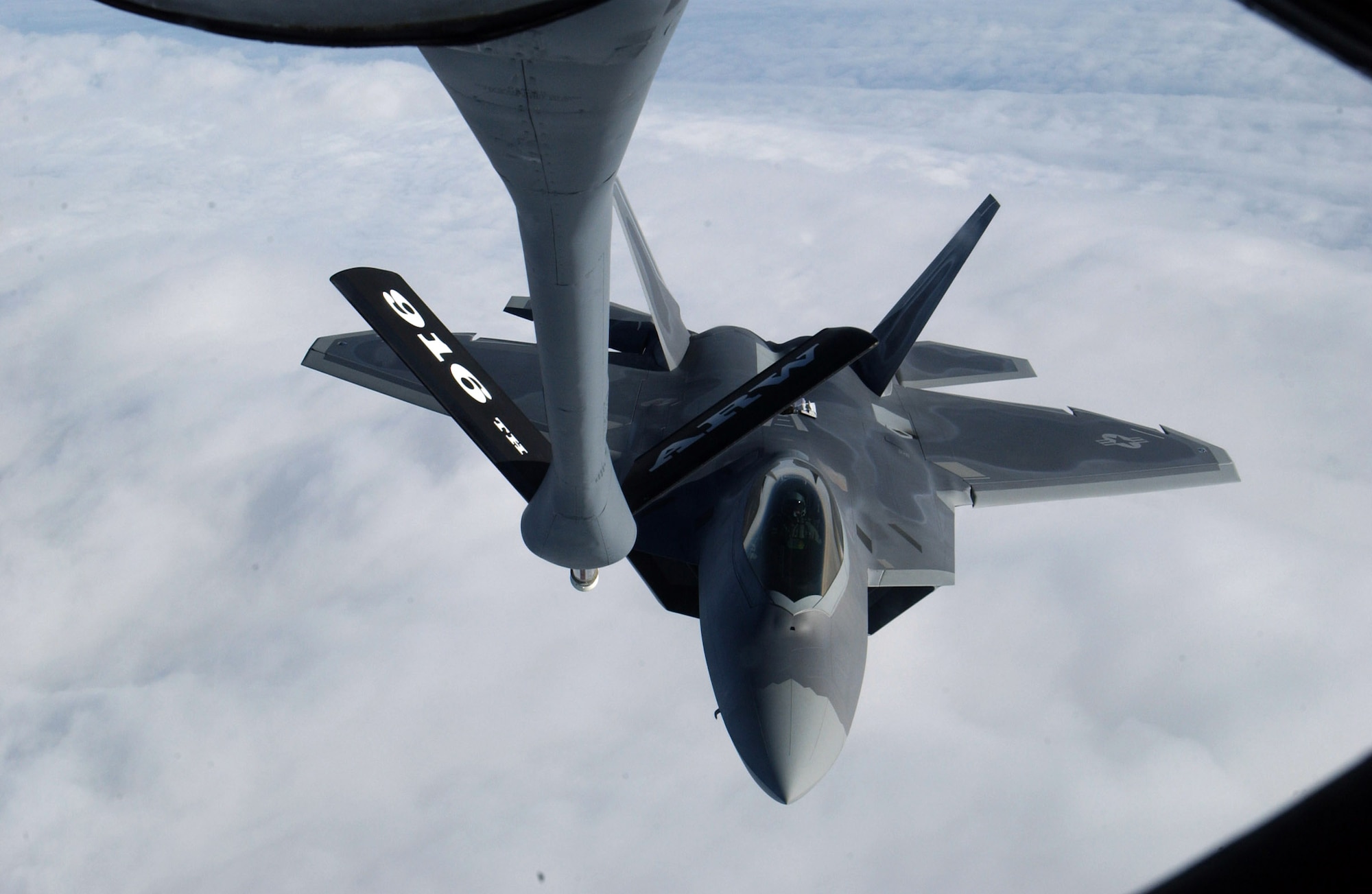 LANGLEY AIR FORCE BASE, Va. (AFPN) -- An F-22A Raptor refuels from a KC-135R Stratotanker Jan. 21. This refueling was part of the Raptor's first operational mission. The KC-135 is with the 916th Air Refueling Wing. (U.S. Air Force photo by Airman Shane Dunaway)