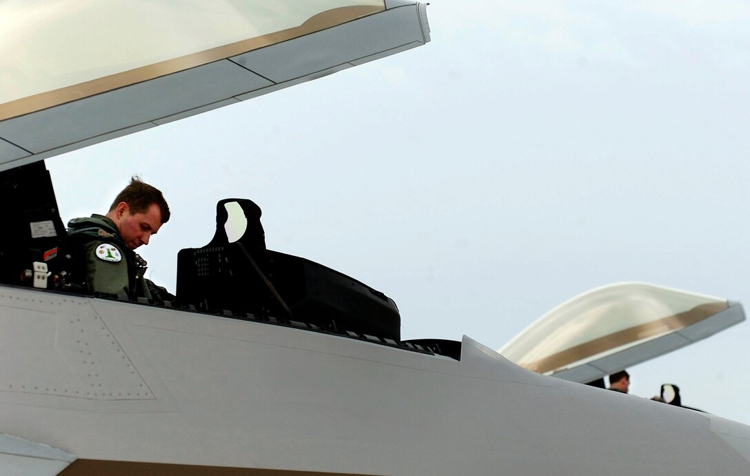 LANGLEY AIR FORCE BASE, Va. (AFPN) -- Col. Thomas Bergeson and Lt. Col. James Hecker prepare to take flight in their respective F-22A Raptors Jan. 21 during an Operation Noble Eagle mission. This historical event marks the first time the F-22A Raptor is participating in the joint services operation to protect American soil. Colonel Bergeson is the 1st Operations Group commander. Colonel Hecker is the 27th Fighter Squadron commander. (U.S. Air Force photo by Staff Sgt. Samuel Rogers) 