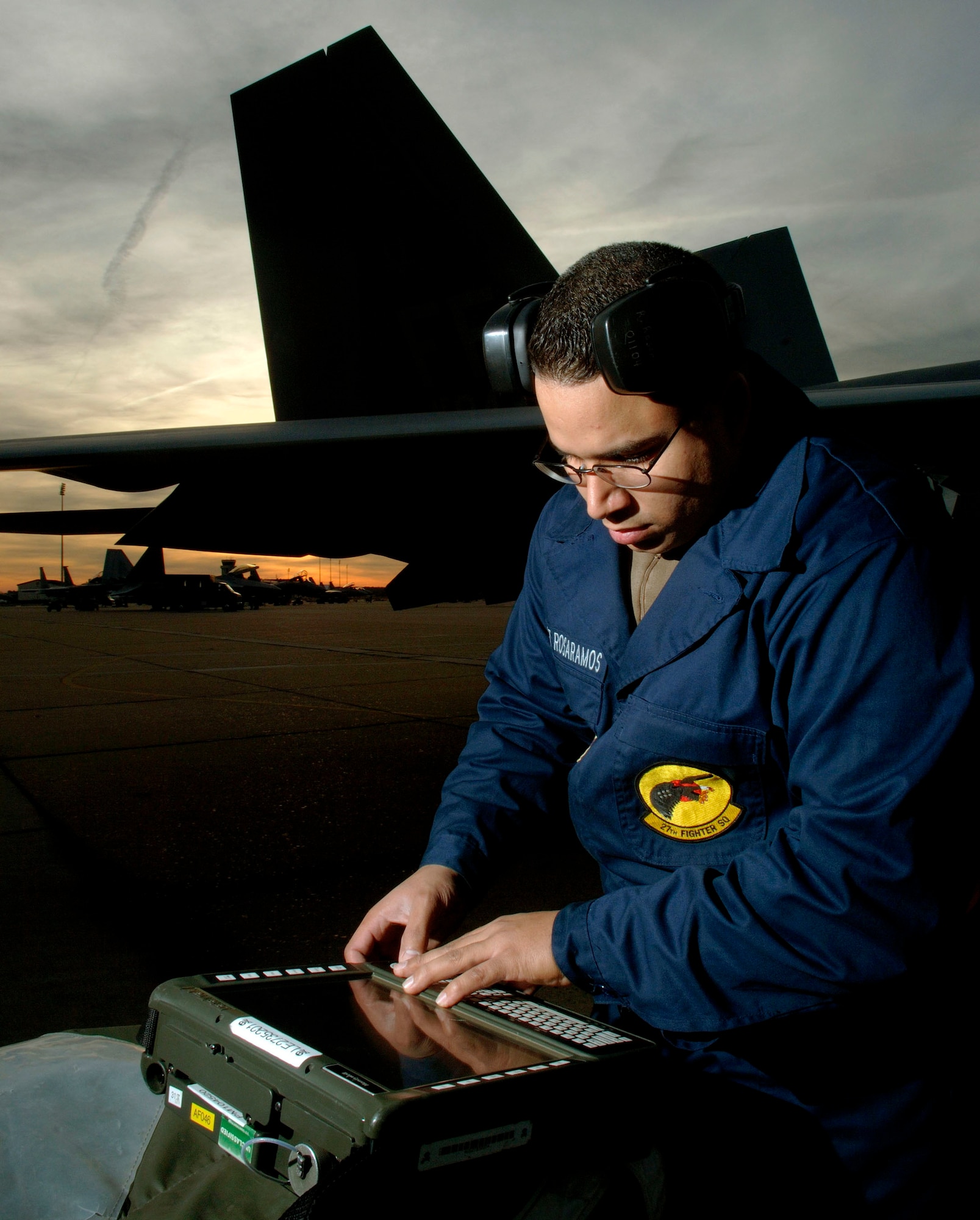 LANGLEY AIR FORCE BASE, Va. (AFPN) -- Staff Sgt. Ramon Rosaramos checks the weapons load status on a portable maintenance adapter in preparation for the F-22A Raptor's first real-world Operation Noble Eagle mission. Sergeant Rosaramos is a weapons loader from the 27th Aircraft Maintenance Squadron. (U.S. Air Force photo by Tech. Sgt. Ben Bloker) 