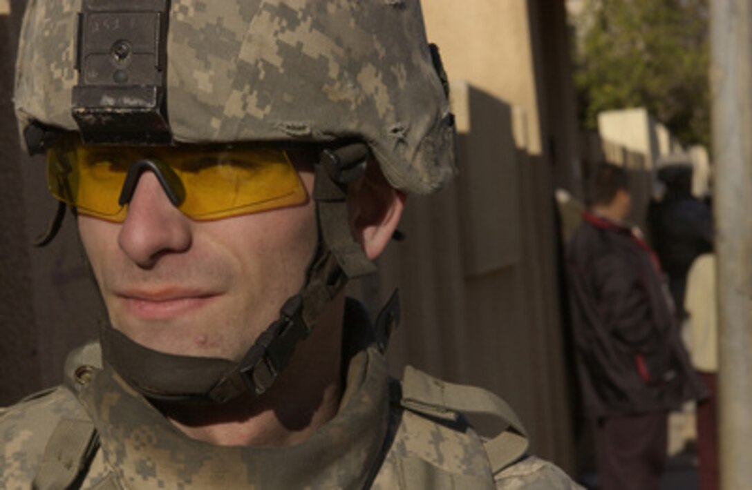 U.S. Army Spc. James Close watches for threats during a joint U.S. and Iraqi Army foot patrol in Mosul, Iraq, on Jan. 21, 2006. Close is attached to Alpha Company, 2nd Battalion, 1st Infantry Regiment, 172nd Stryker Brigade Combat Team. 