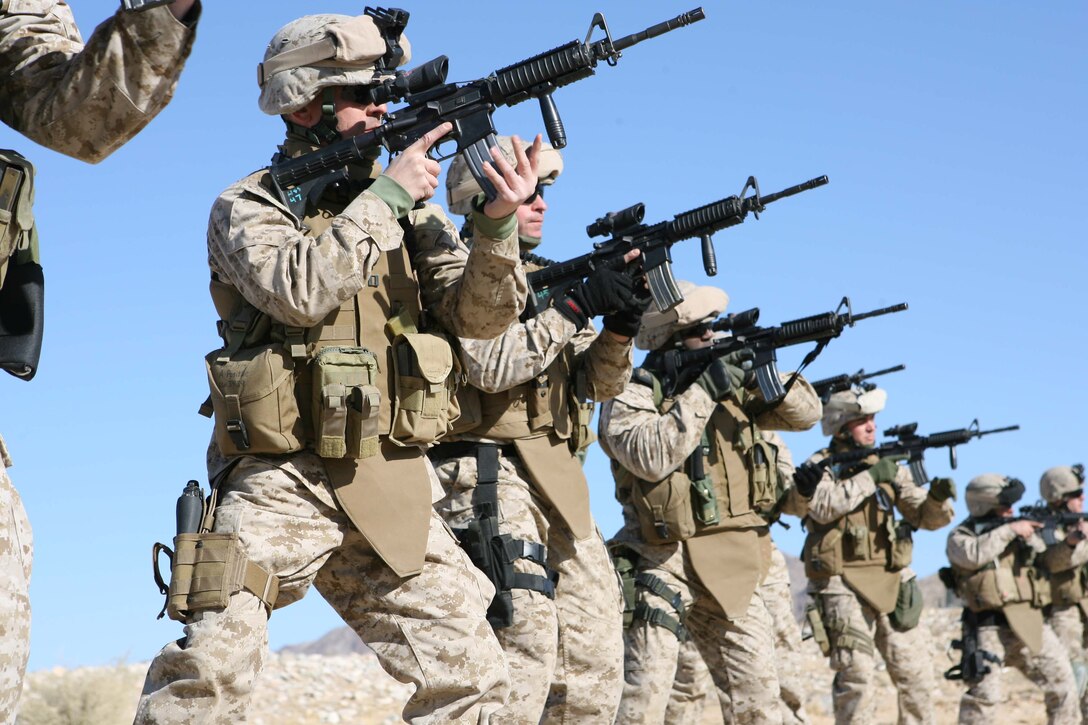 Military Transistion Team members for 3rd Battalion, 8th Marine Regiment quickly reload their rifles during an Enhanced Marksmanship Training simulation held on range 104 at Marine Corps Air Ground Comabat Cenert Twentynine Palms. The goal of the MTT is to train and mentor the Iraqi Security Forces.
