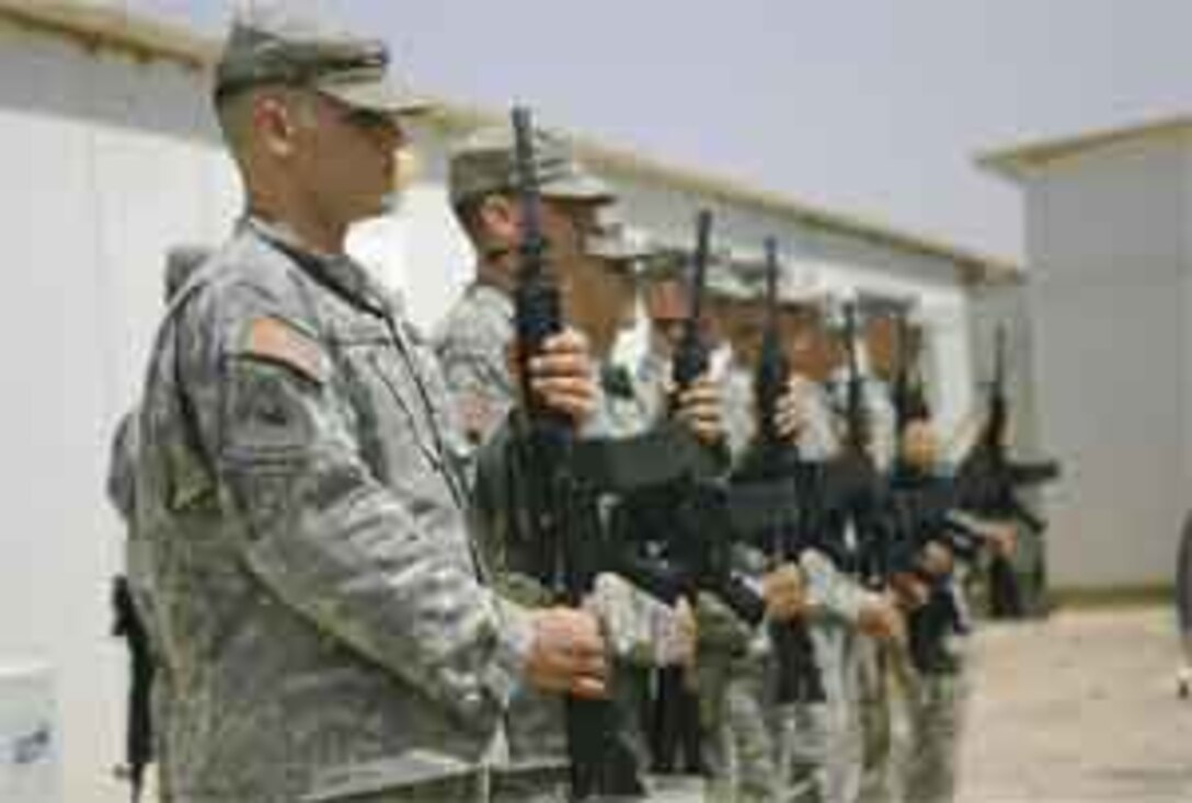 Soldiers perform a ceremonial rifle salute during a memorial service mourning Cpl. Christopher D. Leon at Camp Ramadi June 23, 2006. Leon, a radio operator with 2nd Air Naval Gunfire Liaison Company, was killed June 20, 2006, while conducting operations in the city of Ramadi. The Lancaster, Calif., native was remembered as a friendly, open-hearted individual who was a ?Marine?s Marine? within his unit.