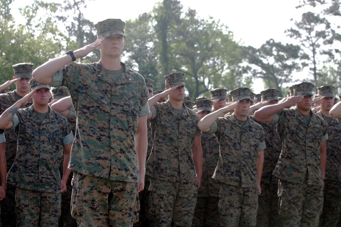 MARINE CORPS BASE CAMP LEJEUNE, N.C. (April 21, 2006)- 1st Lt. Jonathan D. Morris and Marines with 2nd Assault Amphibian Battalion honor the Marines with 2nd Marine Division who were killed in action in support of Operation Iraqi Freedom. The division conducted combat opeartions in the Al Anbar province from February 2005 to February 2006. 265 Marines, sailors and soldiers were honored during the ceremony. (Official U.S. Marine Corps photo by Cpl. Lucian Friel (RELEASED)