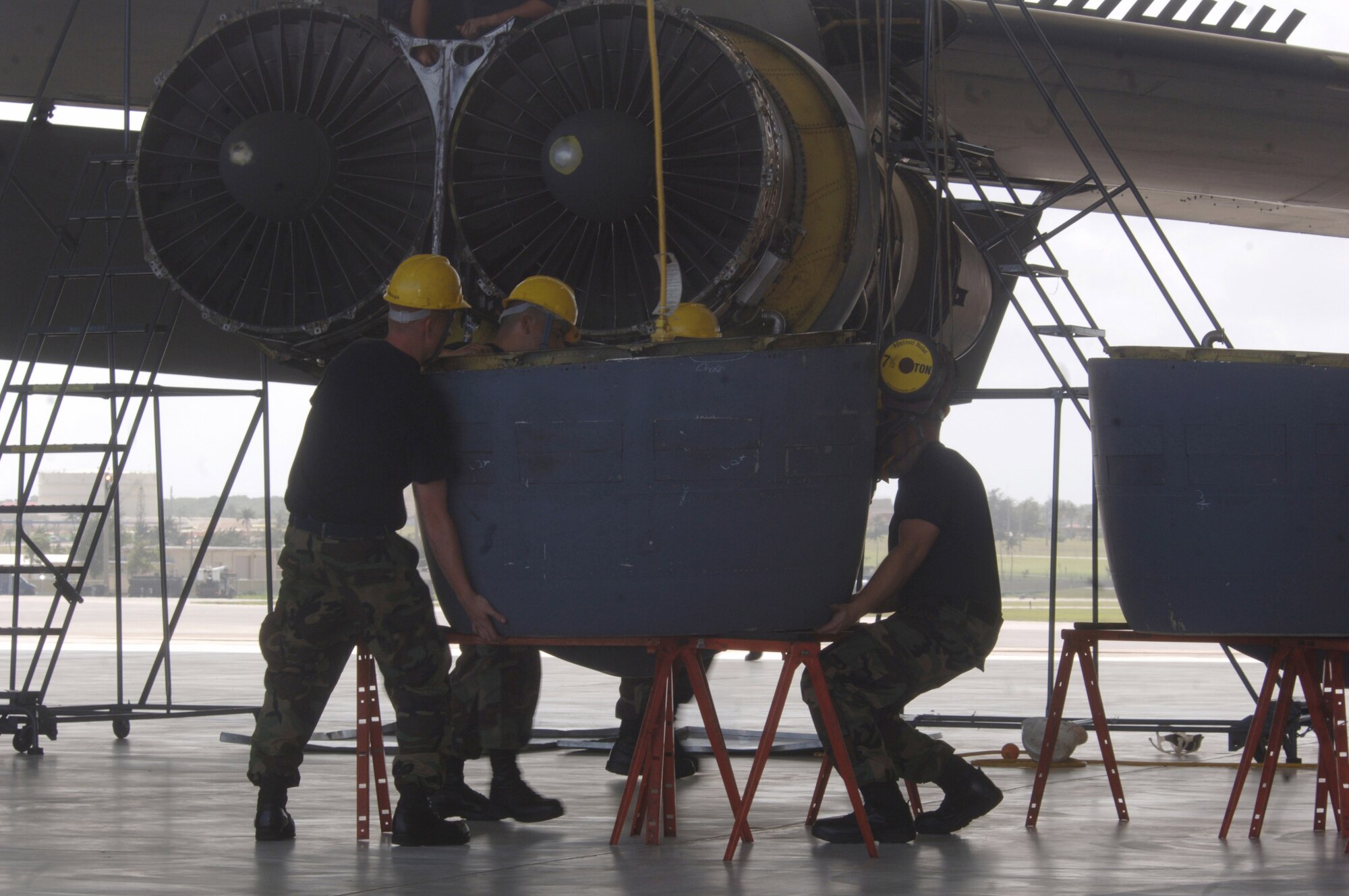 ANDERSEN AIR FORCE BASE, Guam (AFPN) -- Mechanics remove the engine ring cowl of their B-52 Stratofortress aircraft during phase maintenance at Hangar 1 here at Andersen AFB, Guam. The Airmen are deployed from the 2nd Maintenance Squadron based at Barksdale Air Force Base, La. The B-52s come here from a forward-deployed location and go into phase maintenance after 300 flying hours. The $34-million hangar is the newest in the Air Force and can house any type of Air Force aircraft. (U.S. Air Force photo by Master Sgt. Val Gempis)